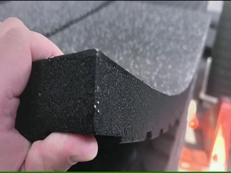 man repairing gym floor with mallet
